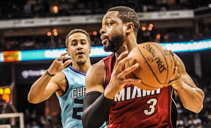 Jan 21, 2015; Charlotte, NC, USA; Miami Heat guard Dwyane Wade (3) looks to pass as he is defended by Charlotte Hornets guard Brian Roberts (22) during the first half of the game at Time Warner Cable Arena. Mandatory Credit: Sam Sharpe-USA TODAY Sports
